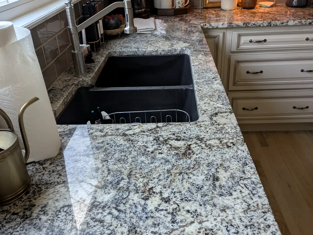 Granite counter and undermount sink wiped clean during a deep clean