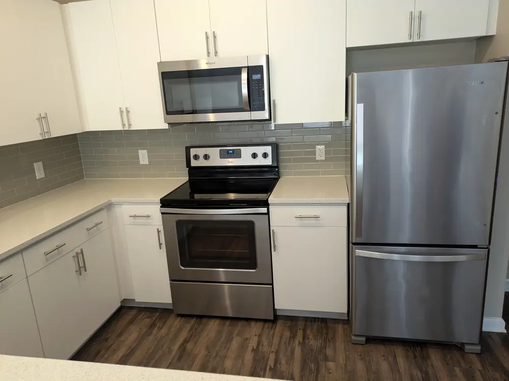 White kitchen with stainless appliances cleaned and ready for new tenants