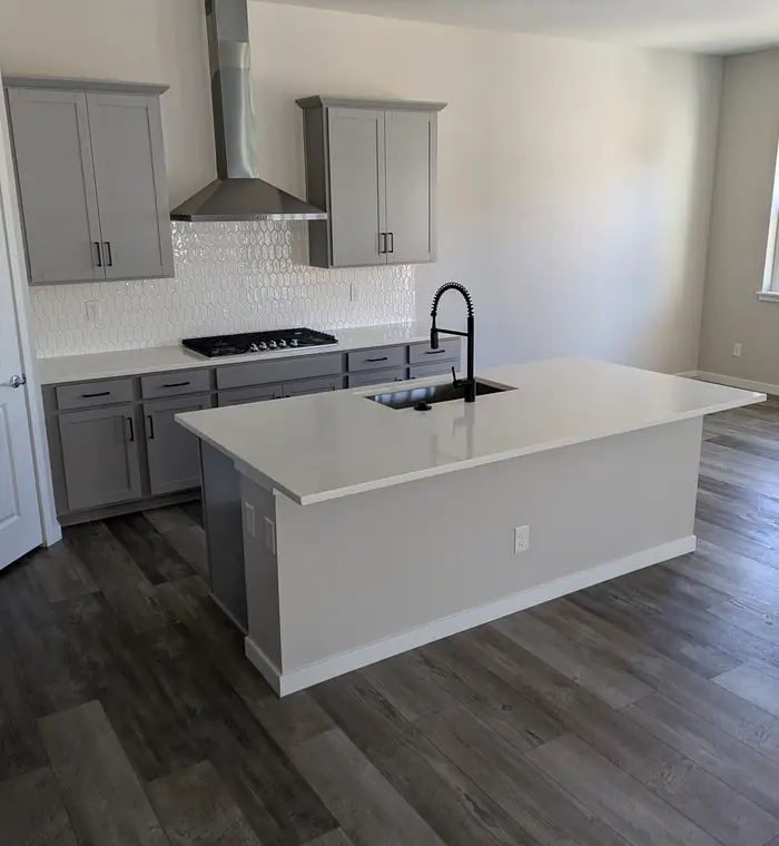 Empty kitchen with a white island, cleaned for move-in